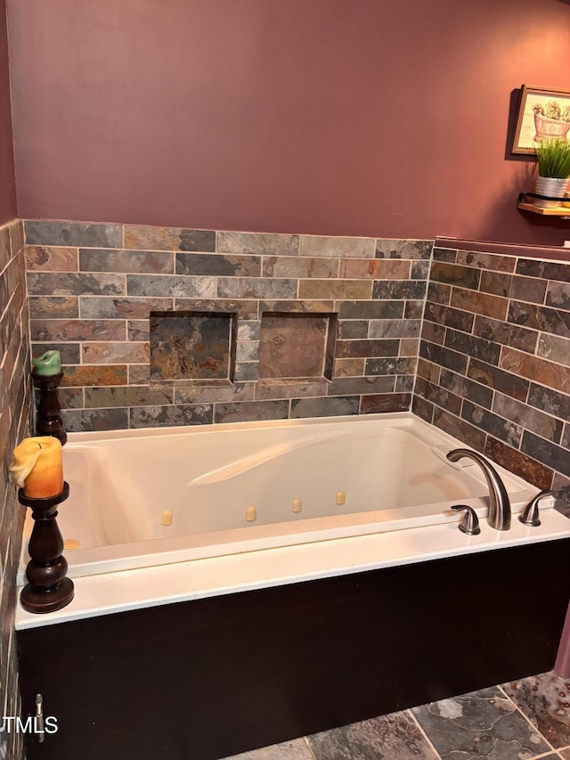 bathroom featuring a tub with jets
