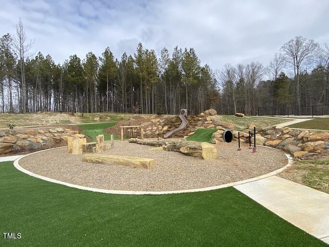 view of playground with a lawn