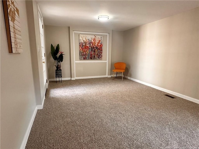 empty room with visible vents, baseboards, and carpet floors