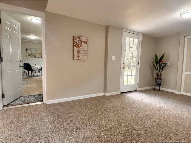 foyer with carpet and baseboards