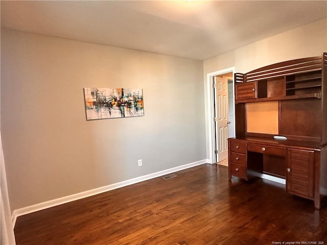 bedroom featuring dark wood finished floors, visible vents, and baseboards