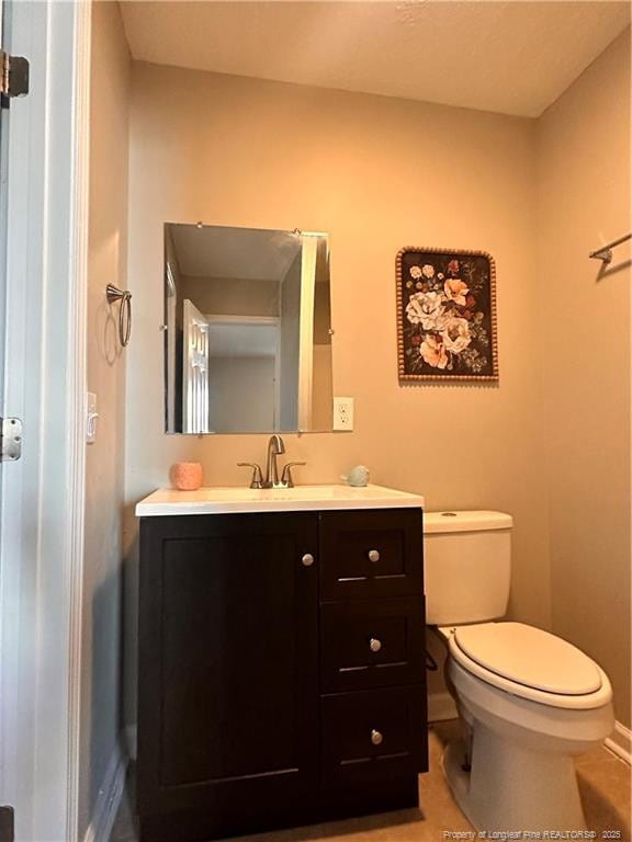 bathroom with vanity, tile patterned floors, and toilet