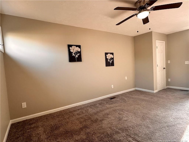 carpeted empty room with visible vents, baseboards, a textured ceiling, and a ceiling fan