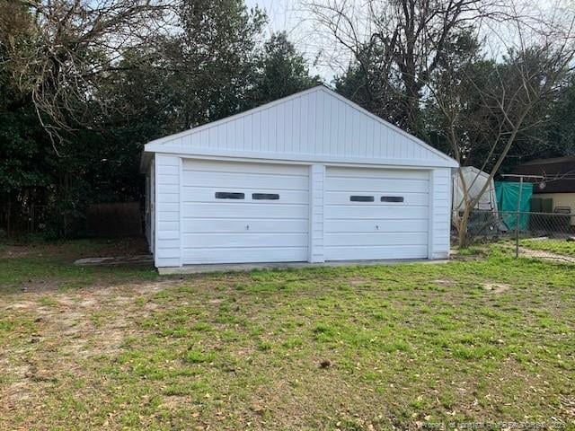 detached garage featuring fence