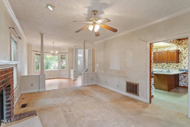 unfurnished living room featuring crown molding, light carpet, a fireplace, ceiling fan, and a textured ceiling