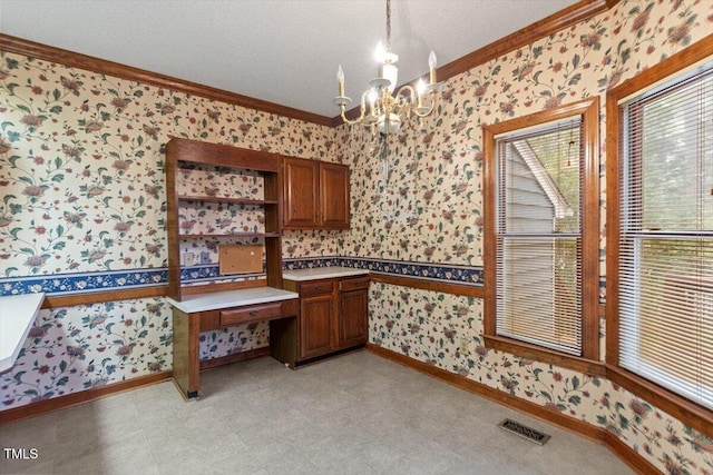 unfurnished dining area featuring wallpapered walls, crown molding, a chandelier, baseboards, and light flooring
