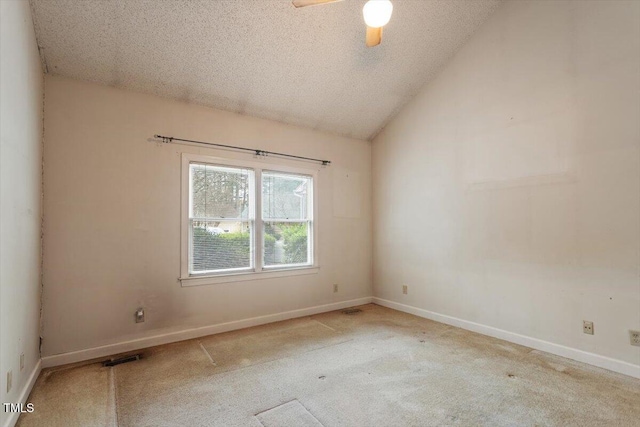 carpeted spare room with a textured ceiling, ceiling fan, baseboards, and lofted ceiling