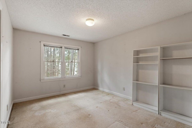 unfurnished bedroom with a textured ceiling, a closet, carpet flooring, and baseboards