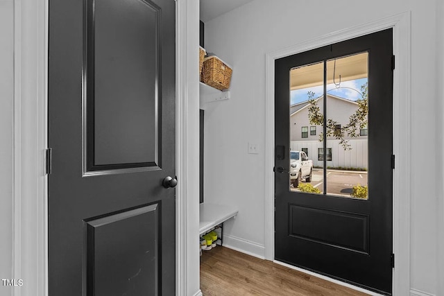 entryway featuring baseboards and wood finished floors