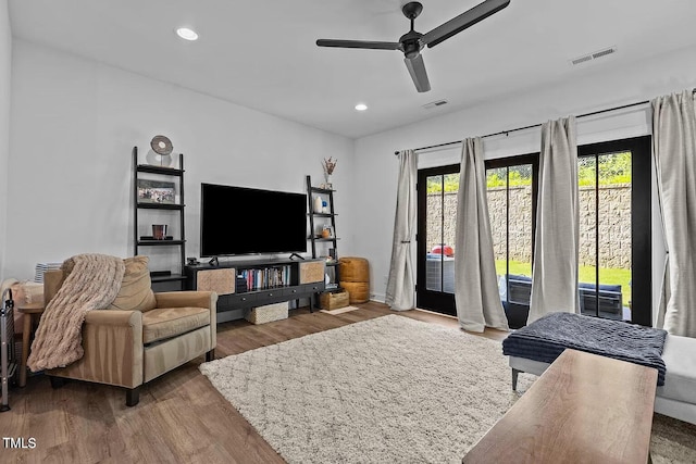 living area featuring visible vents, recessed lighting, a ceiling fan, and wood finished floors