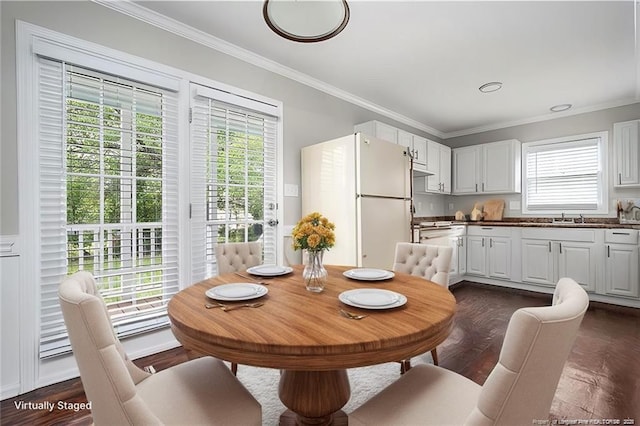 dining area with dark wood finished floors and ornamental molding