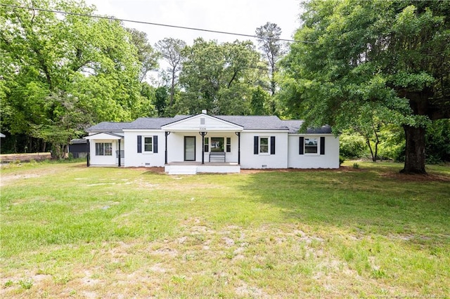 ranch-style house featuring covered porch, a front yard, view of scattered trees, and crawl space