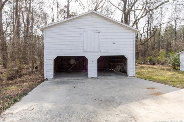 view of side of home with a garage and an outbuilding