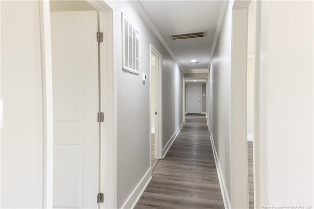 hall with ornamental molding, dark wood finished floors, and baseboards