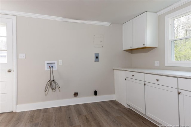 laundry area featuring dark wood-style floors, baseboards, cabinet space, washer hookup, and ornamental molding
