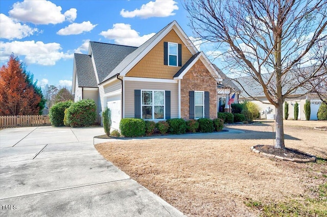 1624 Struble Cir, Willow Springs, NC 27592 - view of front of house featuring concrete driveway, a garage, and stone siding