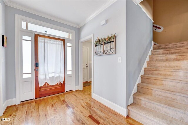 1624 Struble Cir, Willow Springs, NC 27592 - entryway with crown molding, plenty of natural light, wood finished floors, and stairway