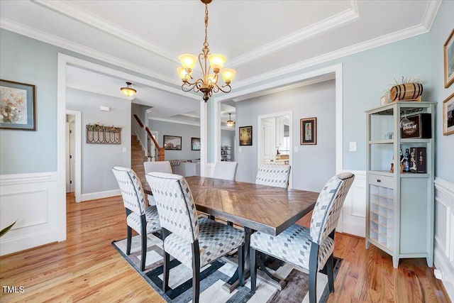 1624 Struble Cir, Willow Springs, NC 27592 - dining room featuring a chandelier, light wood finished floors, stairway, a wainscoted wall, and crown molding