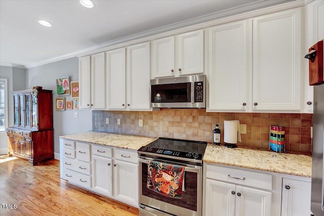 1624 Struble Cir, Willow Springs, NC 27592 - kitchen featuring stainless steel appliances, ornamental molding, white cabinetry, light wood-type flooring, and recessed lighting