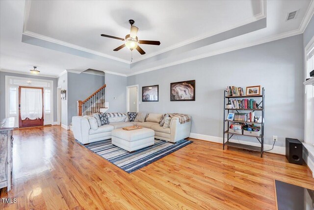 1624 Struble Cir, Willow Springs, NC 27592 - living area featuring a raised ceiling, stairway, wood finished floors, and crown molding