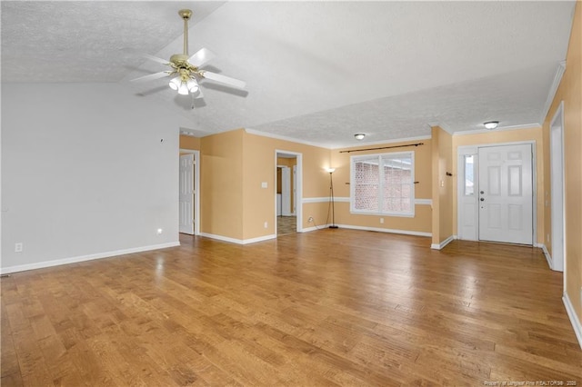 unfurnished living room with a ceiling fan, light wood-style floors, baseboards, and a textured ceiling