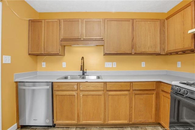 kitchen with range with gas stovetop, a sink, light countertops, and stainless steel dishwasher