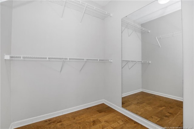 walk in closet featuring wood finished floors