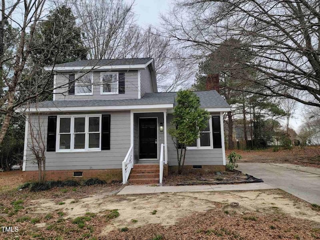 traditional-style house with a shingled roof and crawl space