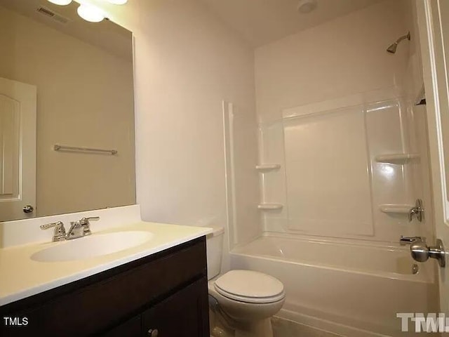 bathroom with vanity, toilet, tub / shower combination, and visible vents