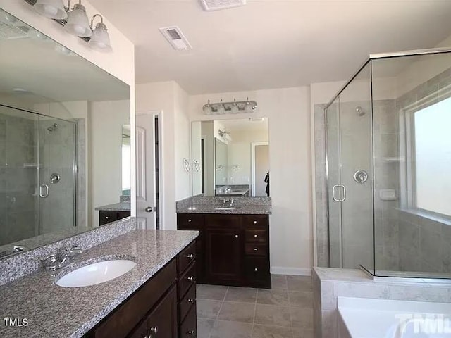 full bath featuring a sink, visible vents, a stall shower, and tile patterned flooring