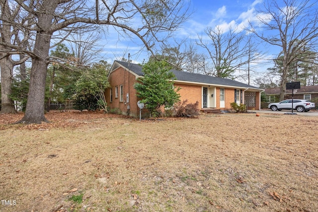 view of front facade with brick siding and roof with shingles