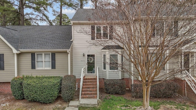 view of front of home featuring a shingled roof and entry steps