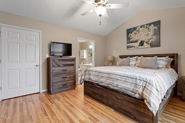 bedroom with connected bathroom, baseboards, lofted ceiling, light wood-style floors, and a ceiling fan