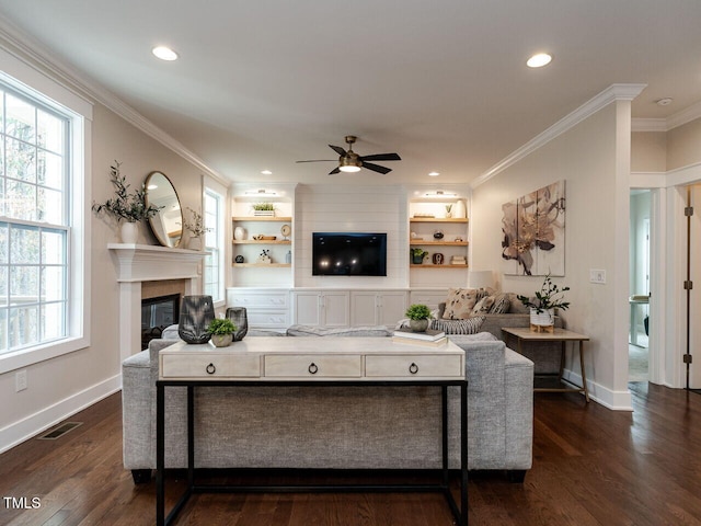 730 Toms Creek Rd, Cary, NC 27519 - living area with ornamental molding, plenty of natural light, a ceiling fan, and a glass covered fireplace