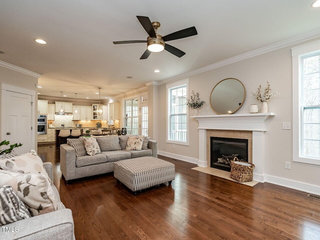 730 Toms Creek Rd, Cary, NC 27519 - living area featuring a ceiling fan, recessed lighting, ornamental molding, a fireplace with flush hearth, and dark wood-type flooring