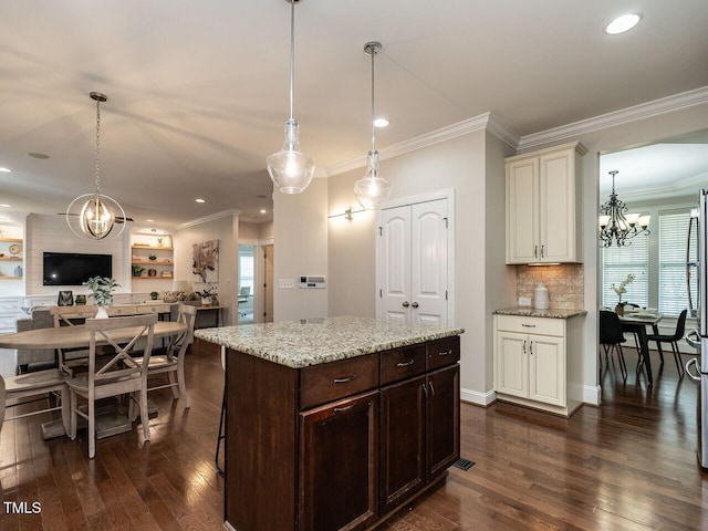 730 Toms Creek Rd, Cary, NC 27519 - kitchen featuring ornamental molding, light stone counters, a chandelier, dark wood-style flooring, and open floor plan