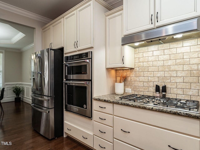 730 Toms Creek Rd, Cary, NC 27519 - kitchen featuring light stone countertops, under cabinet range hood, dark wood finished floors, crown molding, and appliances with stainless steel finishes