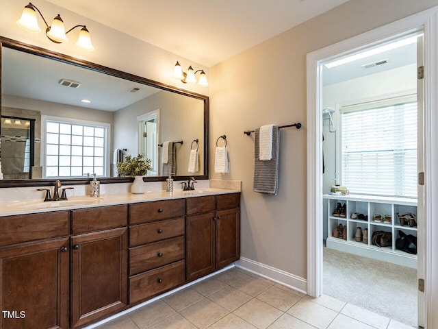 730 Toms Creek Rd, Cary, NC 27519 - full bath with a sink, visible vents, tile patterned floors, a wealth of natural light, and baseboards
