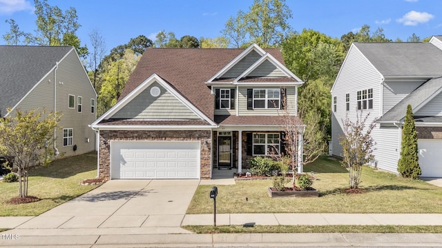 69 Florence Dr, Clayton, NC 27527 - view of front of home featuring concrete driveway, stone siding, a front lawn, a garage, and covered porch