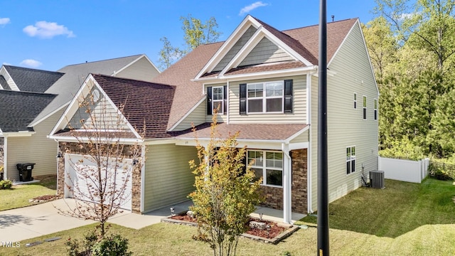 69 Florence Dr, Clayton, NC 27527 - craftsman-style house with concrete driveway, fence, stone siding, a garage, and central AC unit