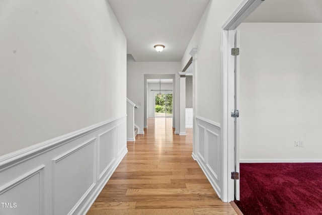 69 Florence Dr, Clayton, NC 27527 - corridor featuring a decorative wall, light wood-style floors, and wainscoting