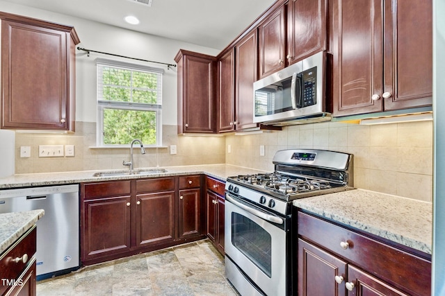 69 Florence Dr, Clayton, NC 27527 - kitchen featuring stainless steel appliances, light stone countertops, tasteful backsplash, and a sink
