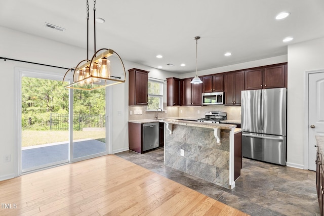 69 Florence Dr, Clayton, NC 27527 - kitchen with tasteful backsplash, visible vents, hanging light fixtures, dark brown cabinets, and stainless steel appliances