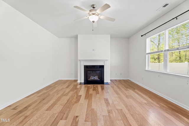69 Florence Dr, Clayton, NC 27527 - unfurnished living room with a fireplace with flush hearth, light wood-style floors, visible vents, and ceiling fan