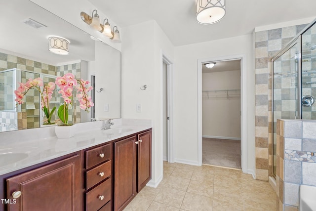 69 Florence Dr, Clayton, NC 27527 - full bath with visible vents, a sink, a spacious closet, tile patterned floors, and a stall shower