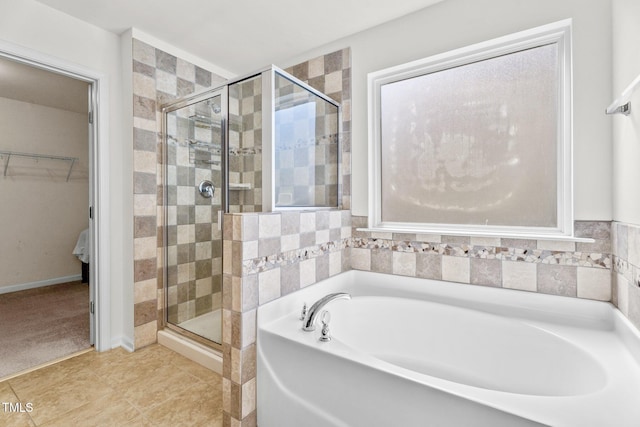 69 Florence Dr, Clayton, NC 27527 - full bathroom with a shower stall, a walk in closet, a bath, and tile patterned flooring