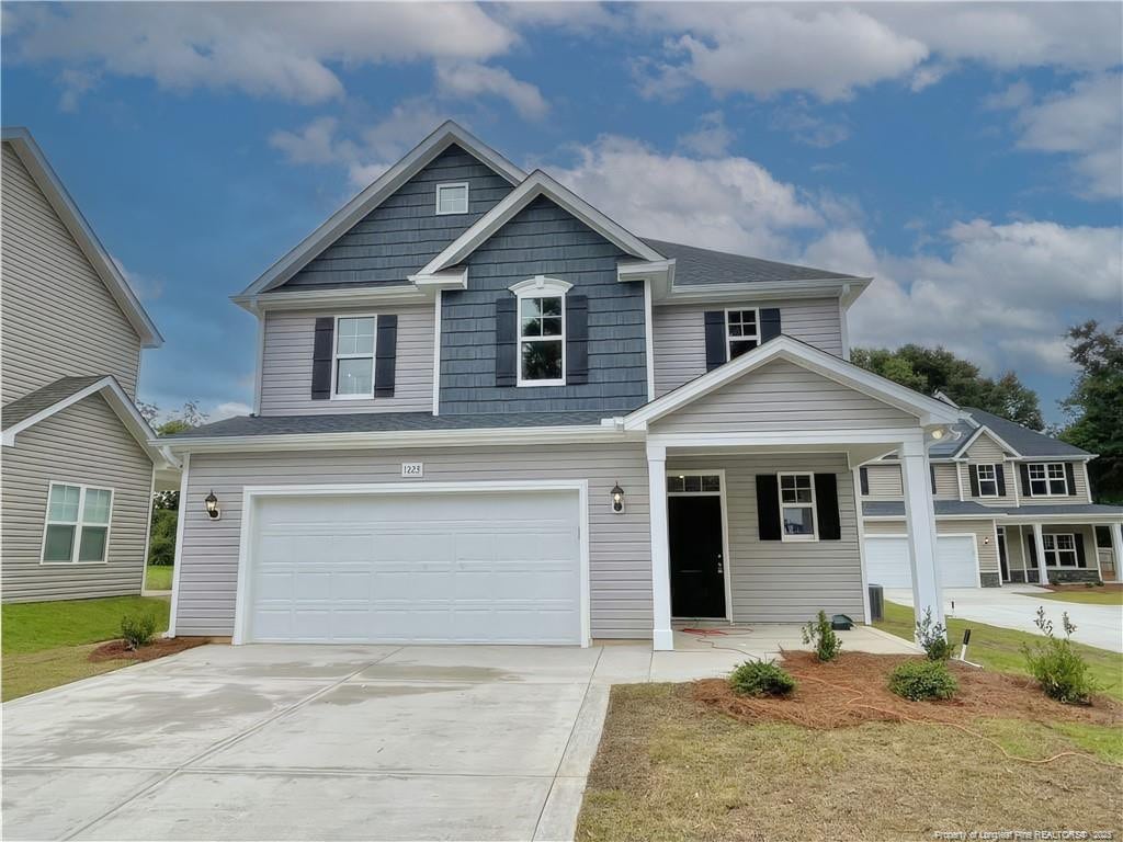 craftsman house with a garage and concrete driveway