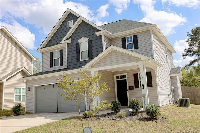 view of front of house with cooling unit, fence, an attached garage, driveway, and a porch