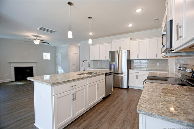 kitchen with white cabinets, a sink, stainless steel appliances, and visible vents