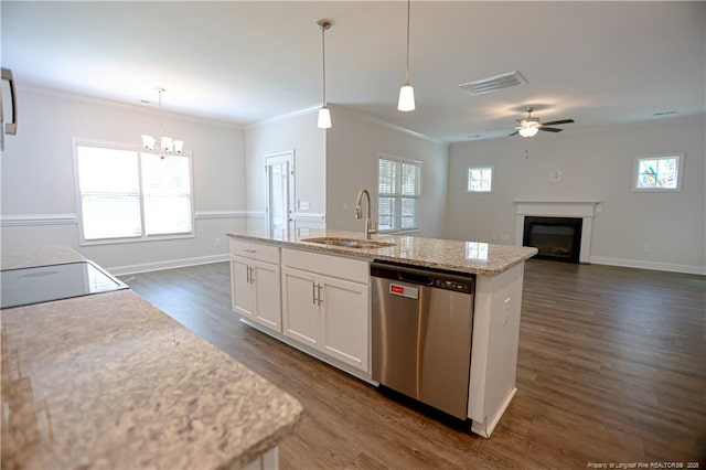 kitchen with a sink, stainless steel dishwasher, a center island with sink, visible vents, and white cabinets